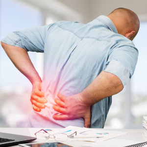 Business man with back pain an office . Pain relief concept
